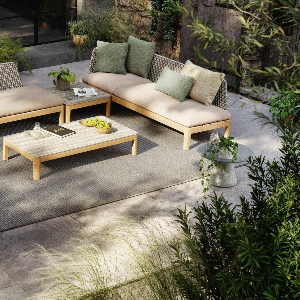 Royal Botania CONIX Beistelltisch in einem Wintergarten mit Rattanmöbeln – natürliche Materialien treffen auf zeitloses Design