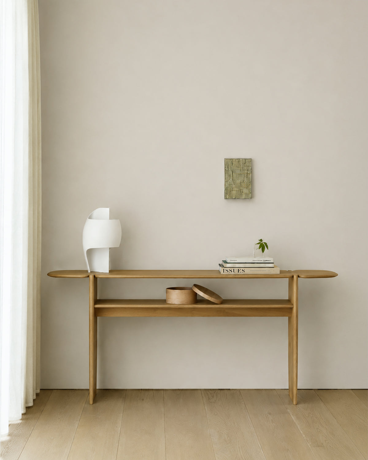 Ethnicraft PI console table, 160x75 cm, made of oak, with decorative items in a bright entryway.