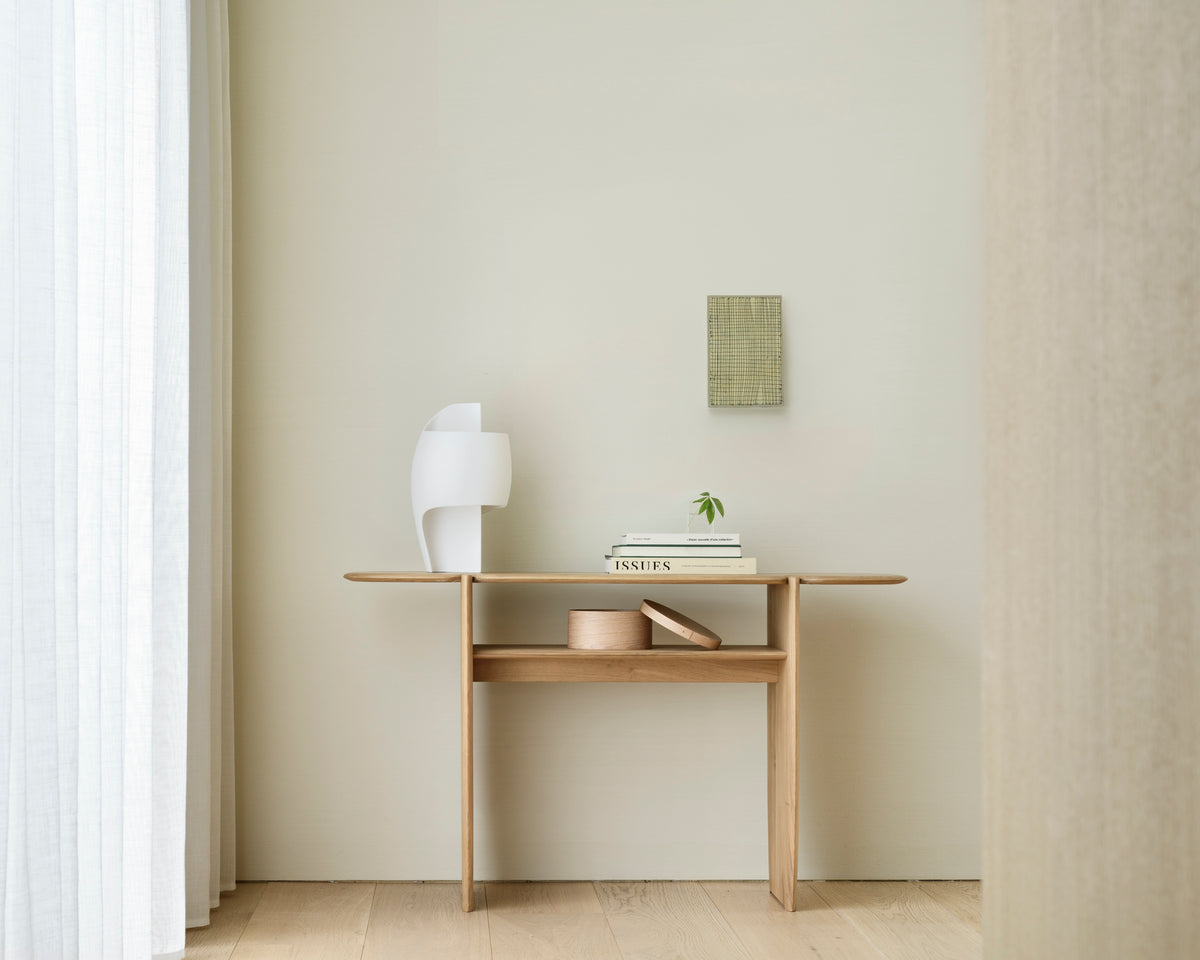 Ethnicraft PI console table, 130x75 cm, made of oak, with decorative items in a bright entryway.