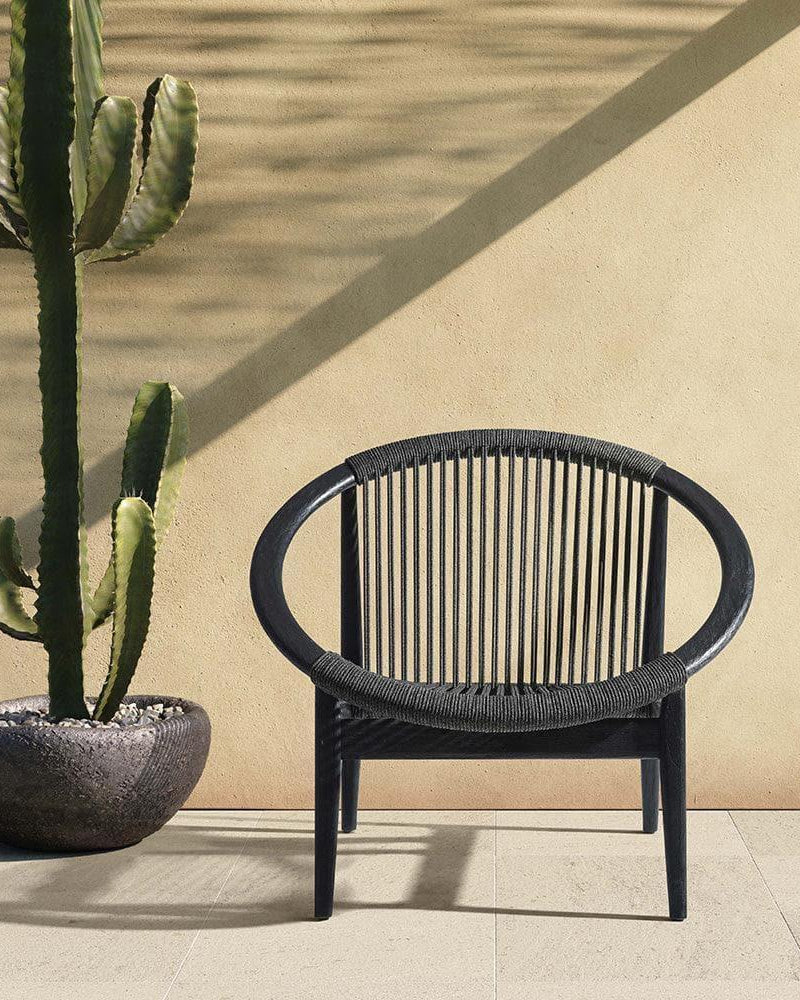 Vincent Sheppard FRIDA garden armchair in Onyx Black on a modern terrace.