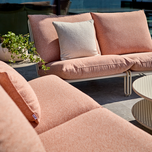 Gemütlcihes Gartensofa Blixt in Farbe Orange von der OUtdoor Marke Brafab auf eine Terrasse.