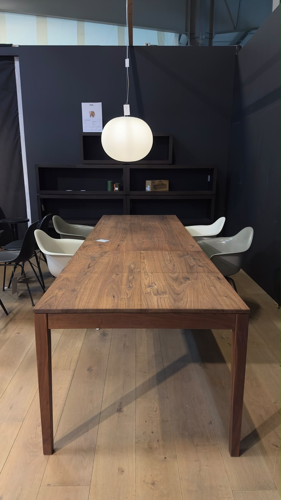 ZEBRA dining table made of naturally oiled walnut, front view, with two extension leaves