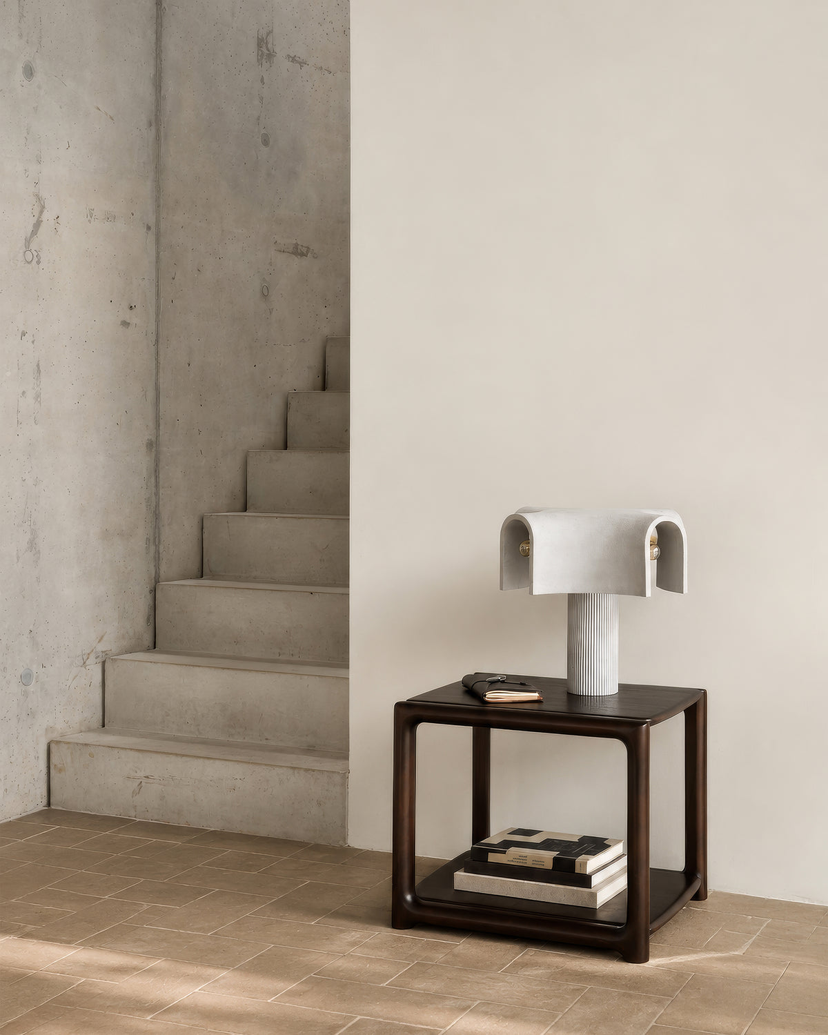 Ethnicraft EDA side table made of mahogany in Rose Brown with organic curves in the entryway.