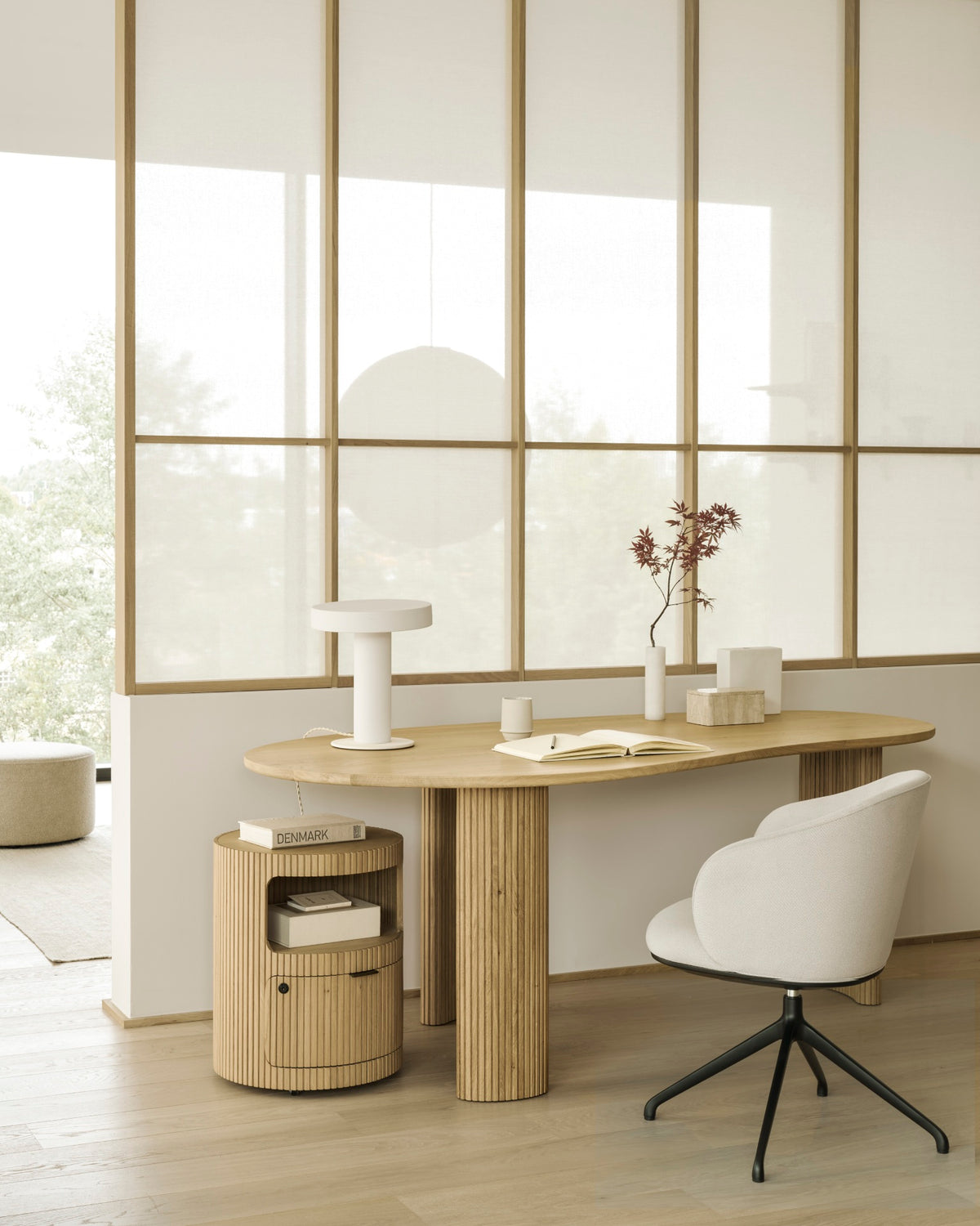 Ethnicraft UNDA office chair in Salt with casters at a desk in a modern home office.