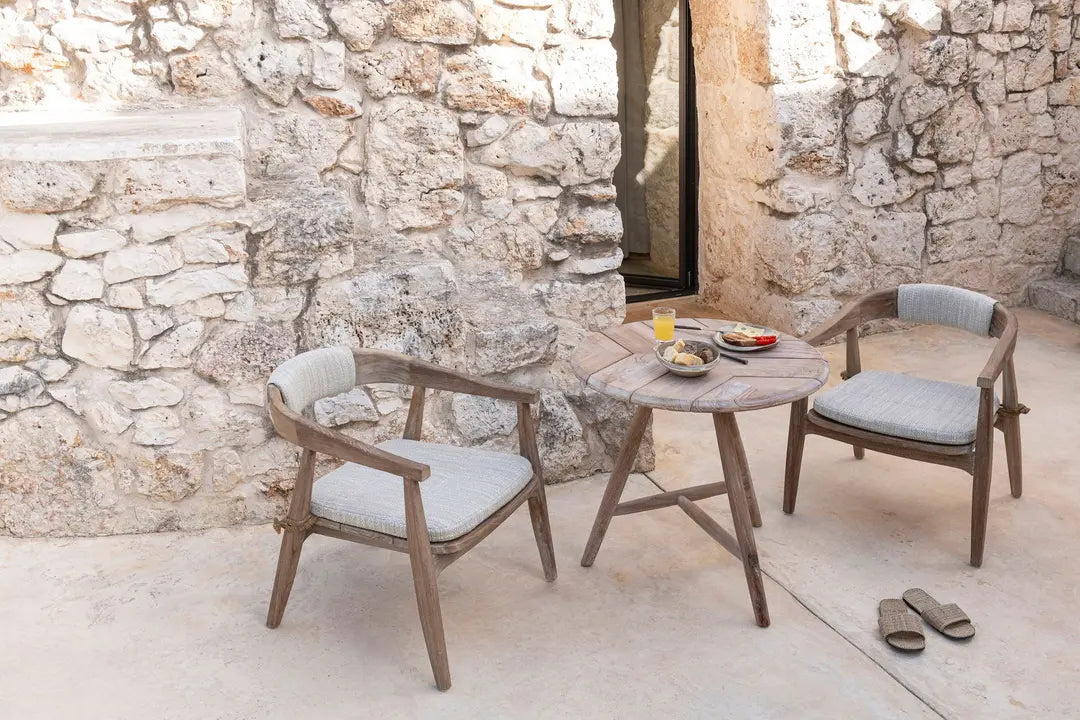 Faye Low bistro table from Gommaire in an outdoor setting - combined with lounge chairs for relaxed coffee drinking on the terrace